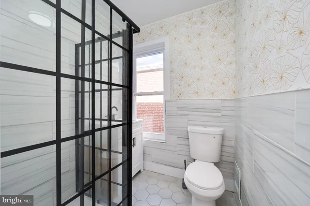 a white toilet sitting next to a bathroom sink
