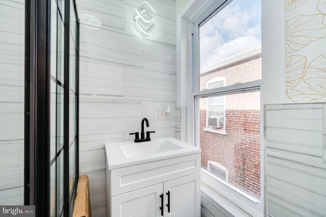 a bathroom with a sink and a window