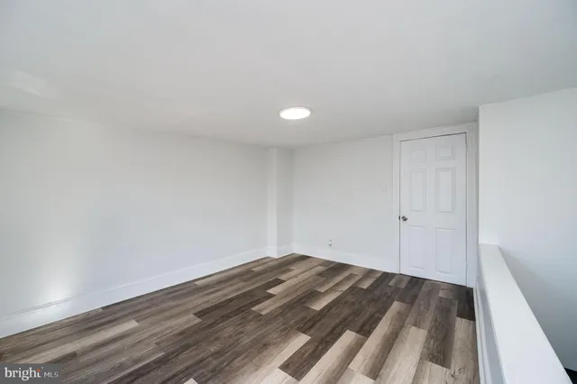 a view of room with window and wooden floor