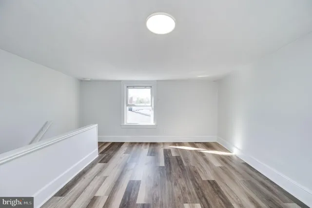 a view of room with window and hardwood floor