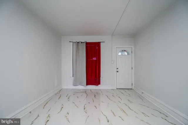 a view of a room with wooden floor and bathroom