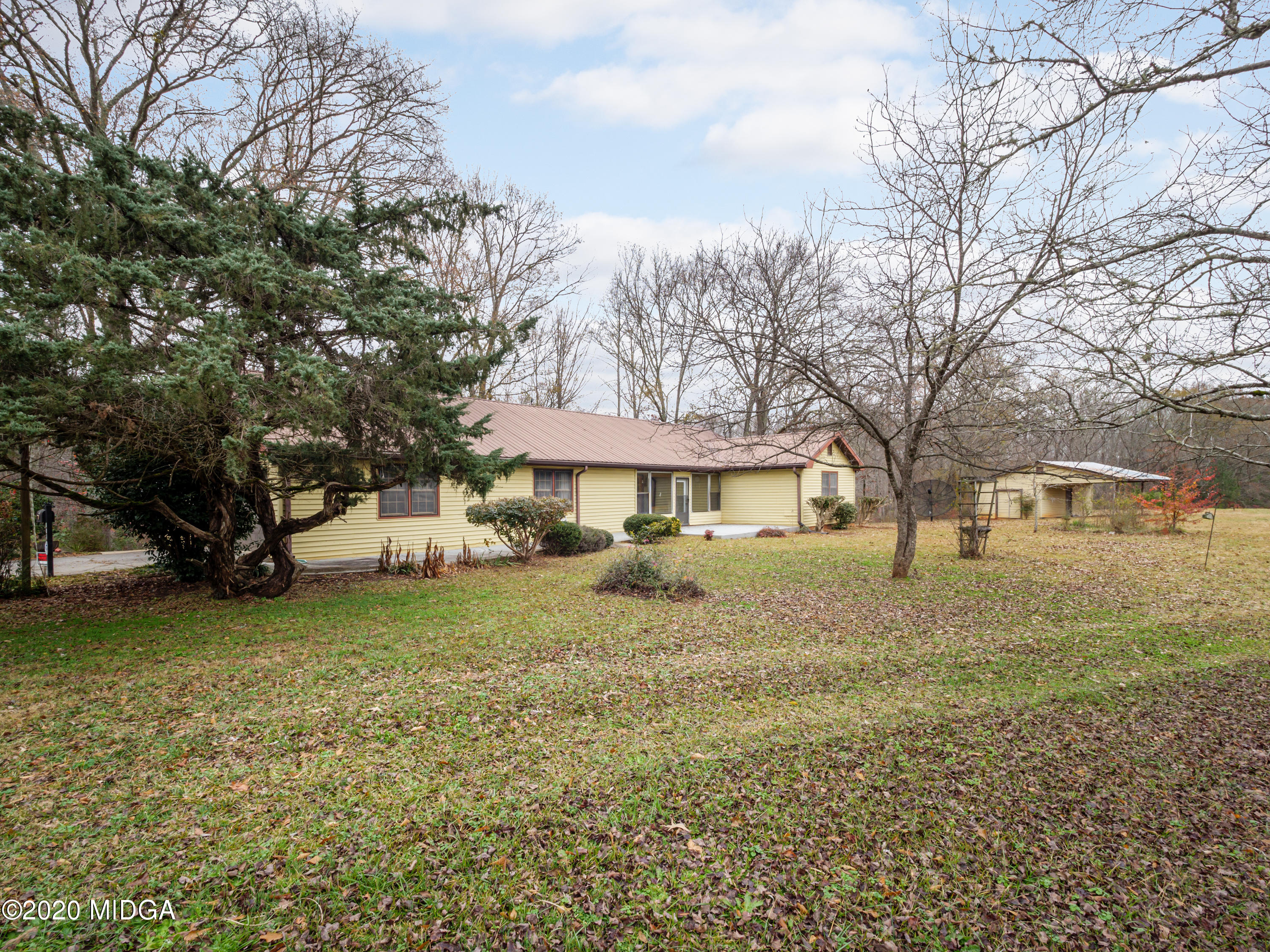 115 Hasty Road Jackson, GA 30233 - Photo 33 of 36 a view of a yard with a house and a tree