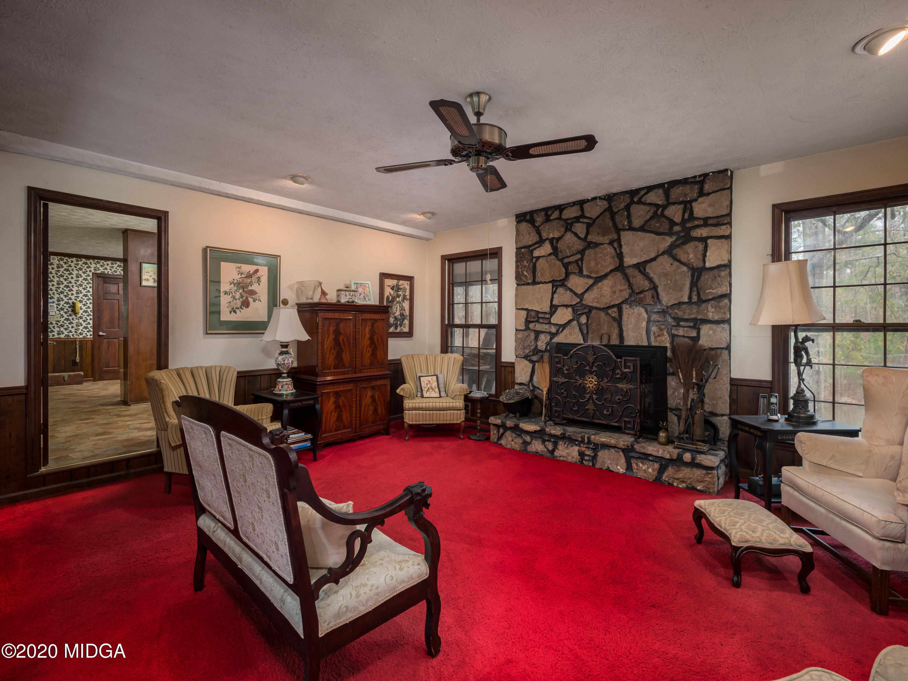 115 Hasty Road Jackson, GA 30233 - Photo 7 of 36 a living room with furniture a flat screen tv and a fireplace