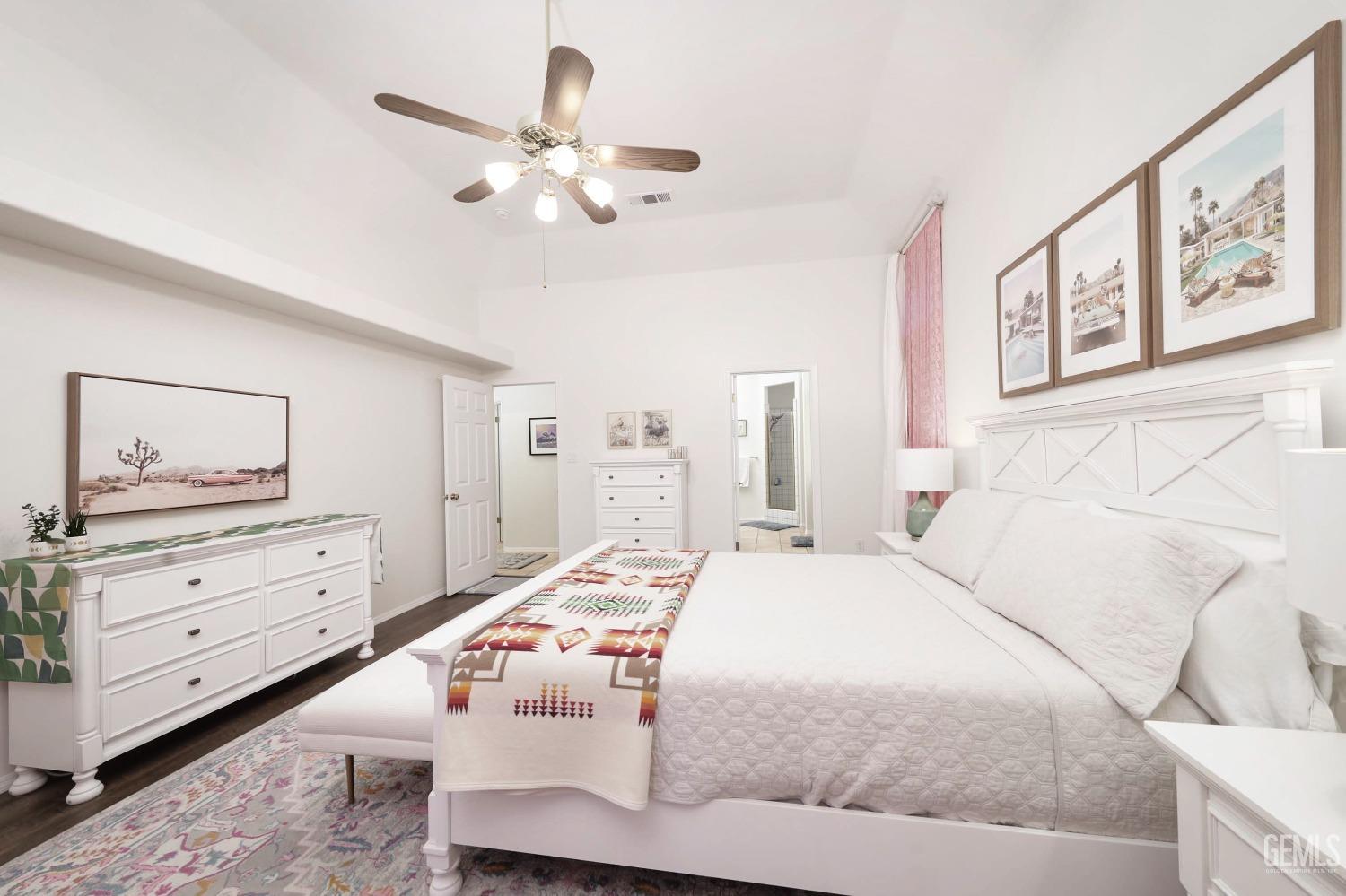 Undisclosed Address Bakersfield, CA 93312 - Photo 12 of 39 a bedroom with a large bed and a chandelier