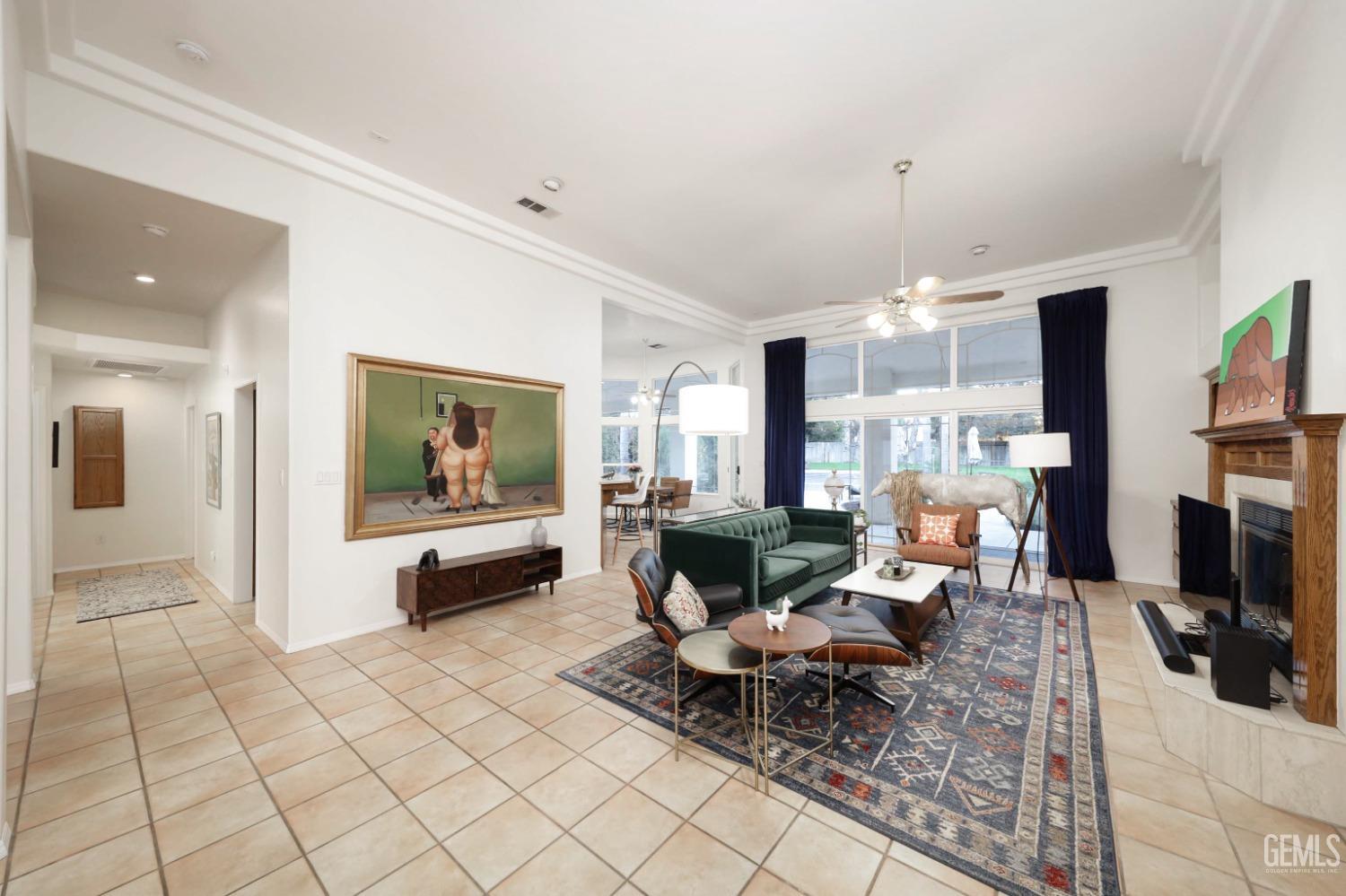 Undisclosed Address Bakersfield, CA 93312 - Photo 5 of 39 a living room with furniture a dining table and a fireplace