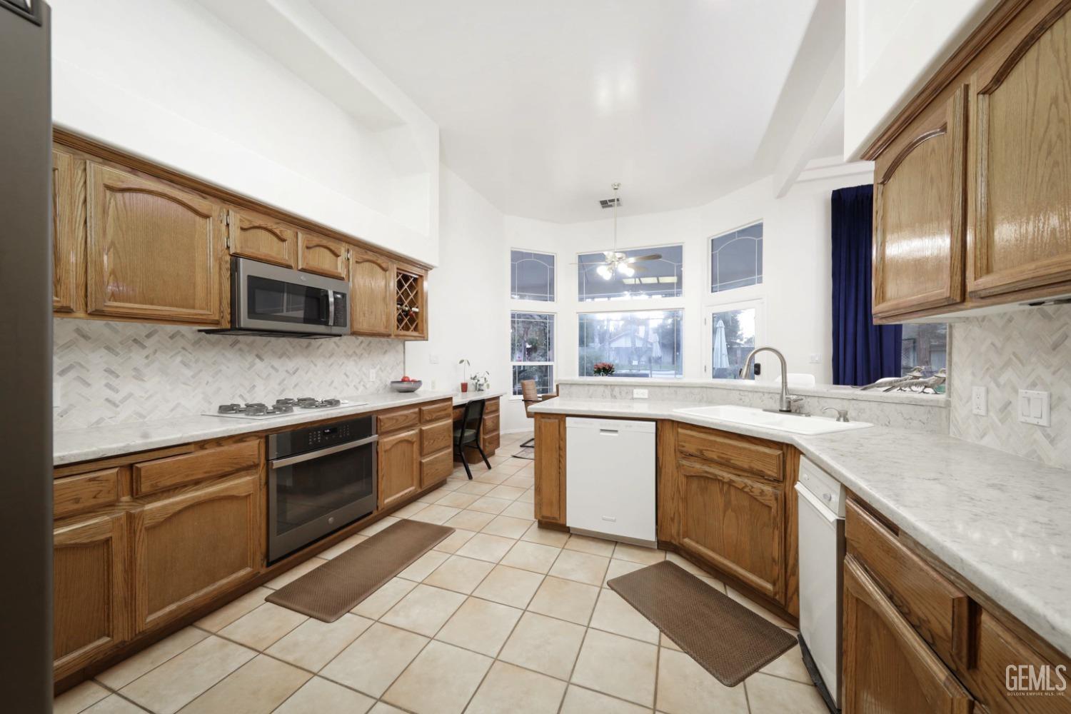 Undisclosed Address Bakersfield, CA 93312 - Photo 7 of 39 a kitchen with stainless steel appliances granite countertop a sink and stove top oven