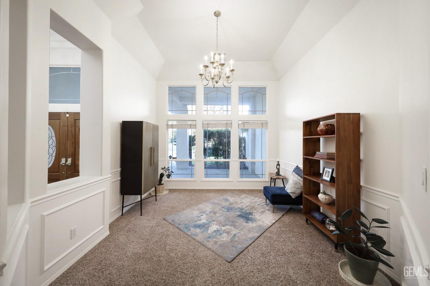 Undisclosed Address Bakersfield, CA 93312 - Photo 9 of 39 a living room with furniture and a chandelier