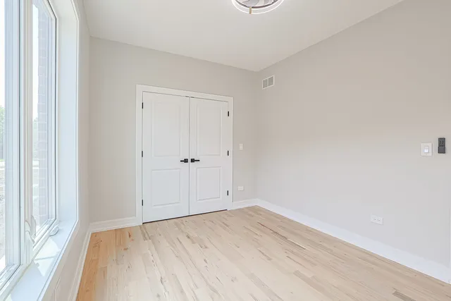 an empty room with wooden floor