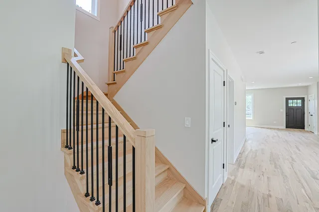 a view of a hallway with wooden floor and entryway