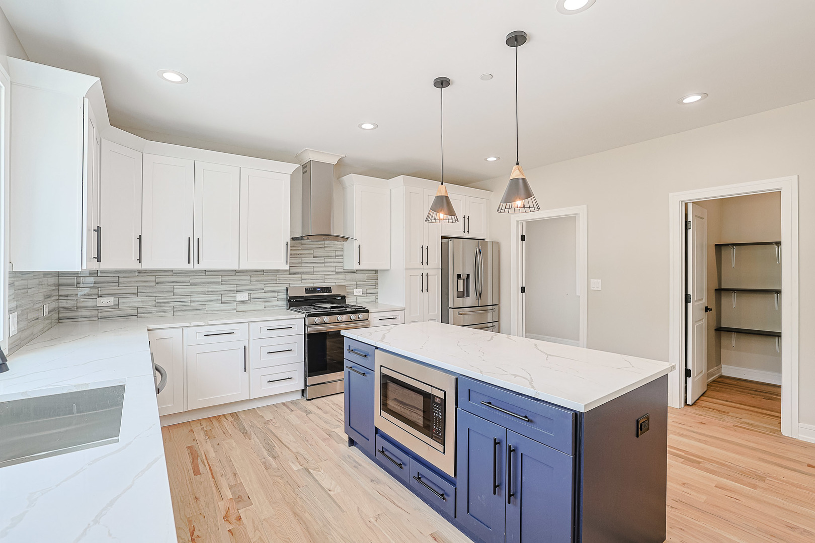 7948 West 74th Avenue Bridgeview, IL 60455 - Photo 16 of 39 a kitchen with a stove kitchen island and stainless steel appliances