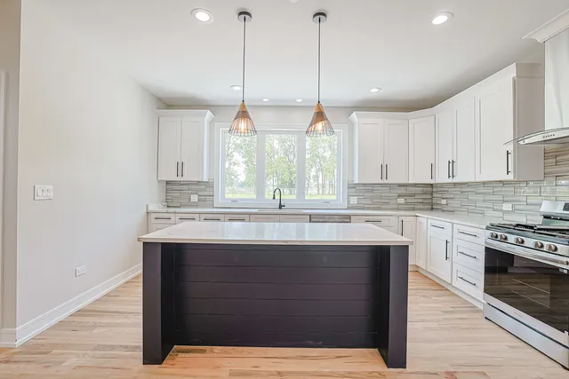 a kitchen with a sink cabinets and window