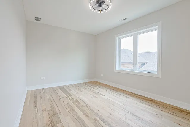 a view of room with window and hardwood floor
