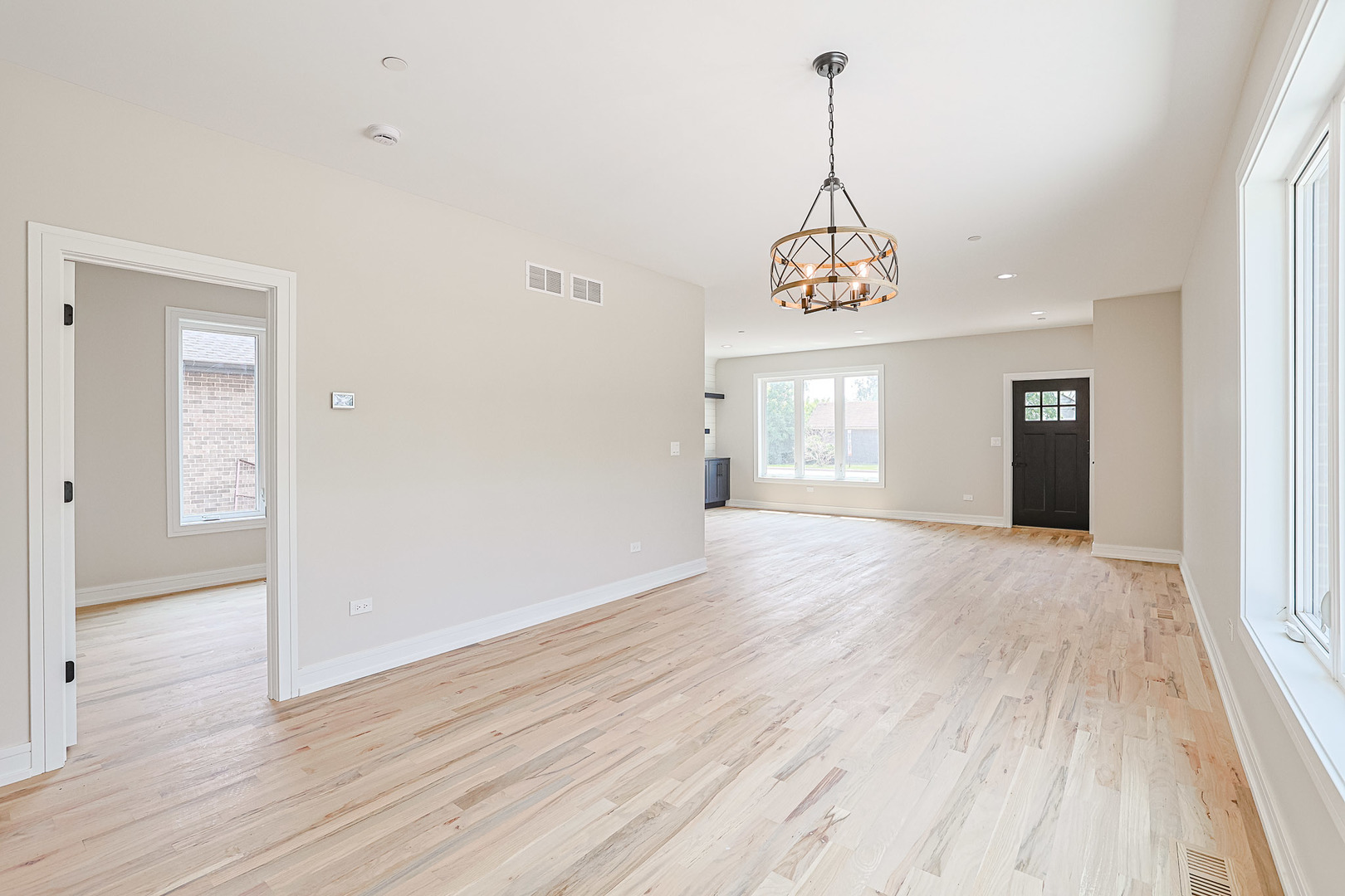 7948 West 74th Avenue Bridgeview, IL 60455 - Photo 38 of 39 a view of an empty room with wooden floor and windows
