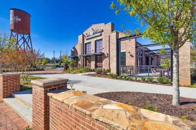 a street sign on a sidewalk next to a road