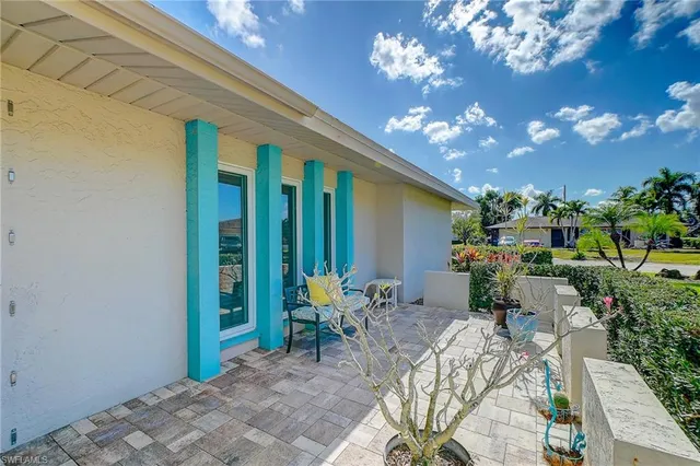 a view of a patio with plants and chairs