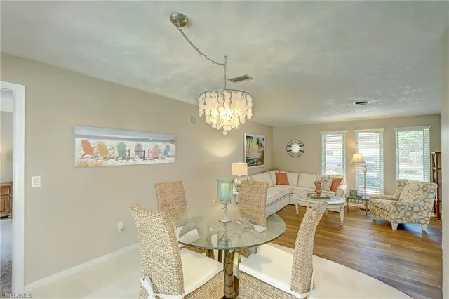 a view of a dining room with furniture wooden floor and chandelier