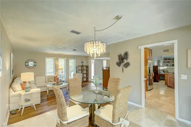 a view of a dining room with furniture and chandelier