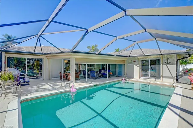 a patio with a table and chairs under an umbrella