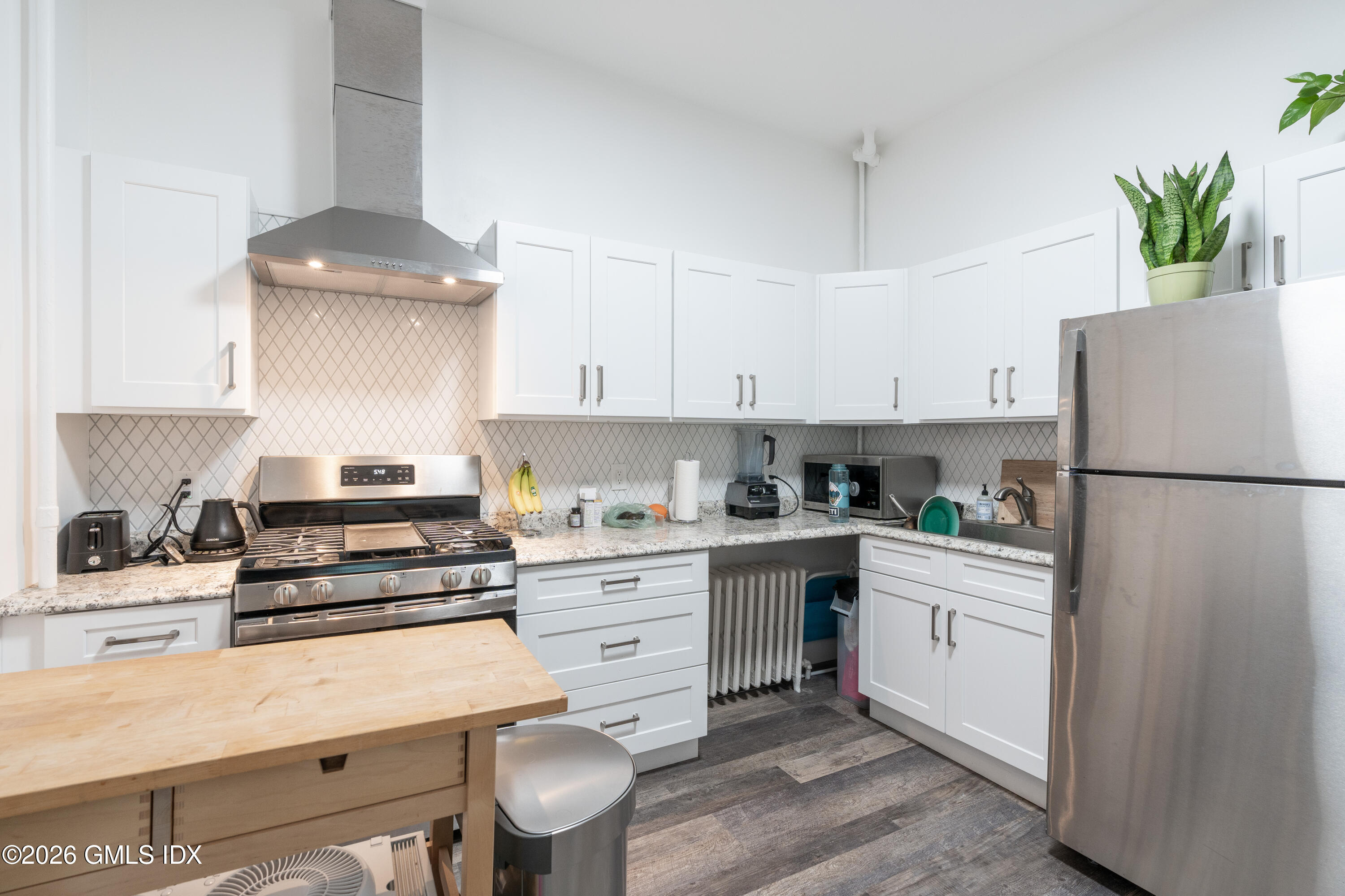 a kitchen with a white cabinets and white appliances