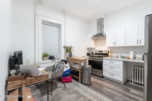a kitchen with a sink stove and cabinets