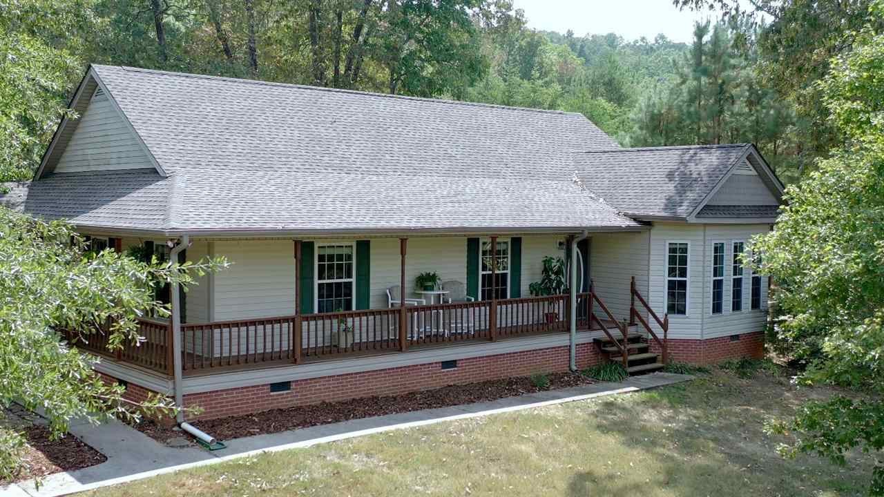 a view of a house with garden and deck