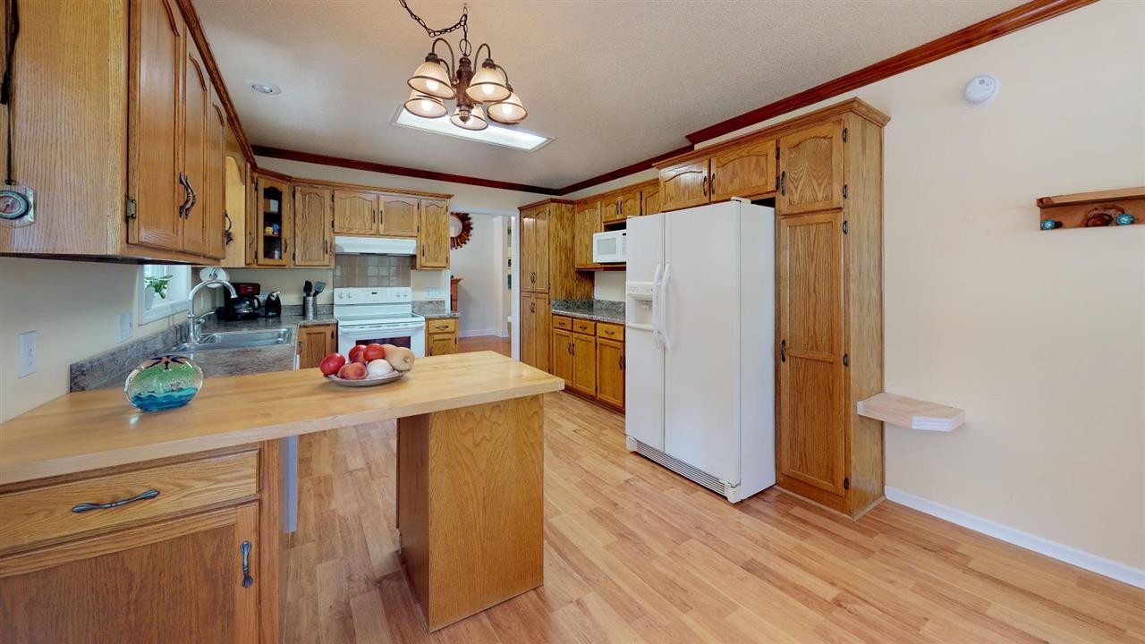 2286 Old Federal Road Ocoee, TN 37361 - Photo 12 of 56 a kitchen with stainless steel appliances a refrigerator sink and wooden floor