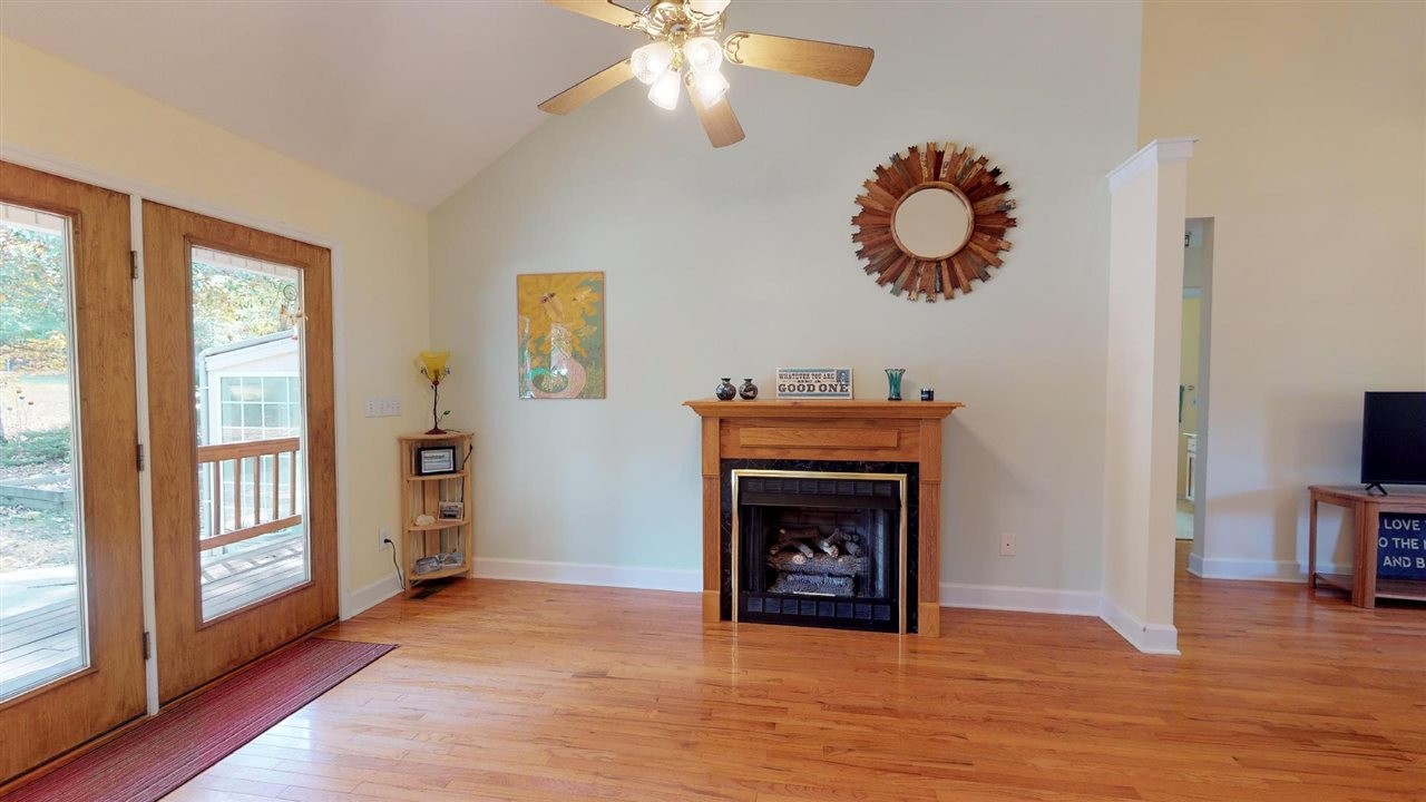 2286 Old Federal Road Ocoee, TN 37361 - Photo 6 of 56 a view of a livingroom with a fireplace wooden floor and windows