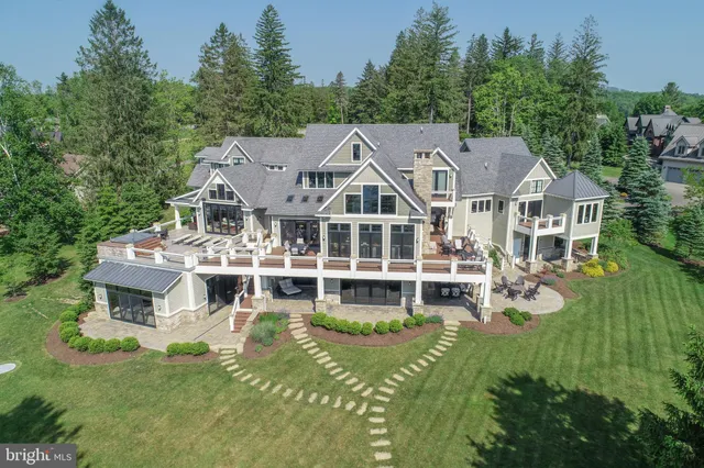 a aerial view of a house with a big yard and potted plants