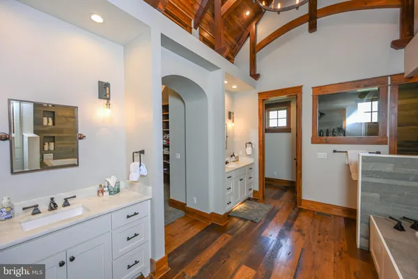 a bathroom with a granite countertop shower sink and mirror