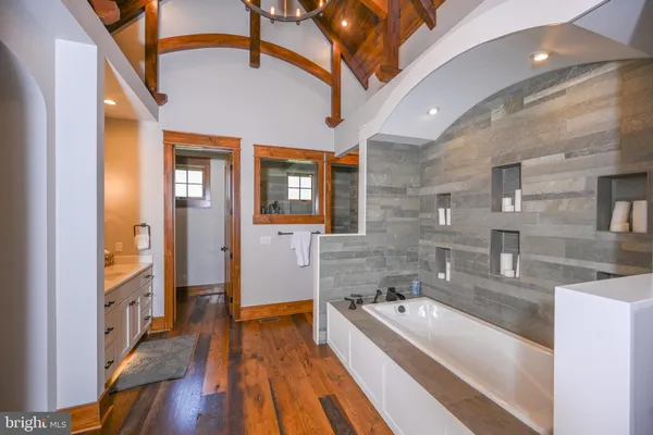 a spacious bathroom with a granite countertop double vanity sink mirror and