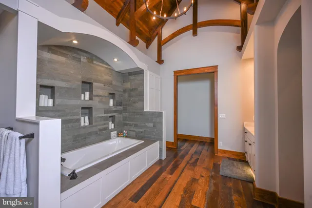 a spacious bathroom with a granite countertop double vanity sink mirror and
