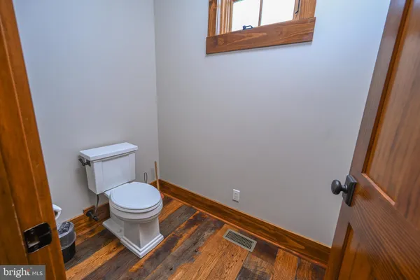 a kitchen with stainless steel appliances granite countertop a sink a stove and a wooden floors