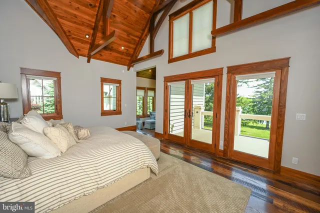 a kitchen with stainless steel appliances granite countertop a sink a stove and a wooden floors