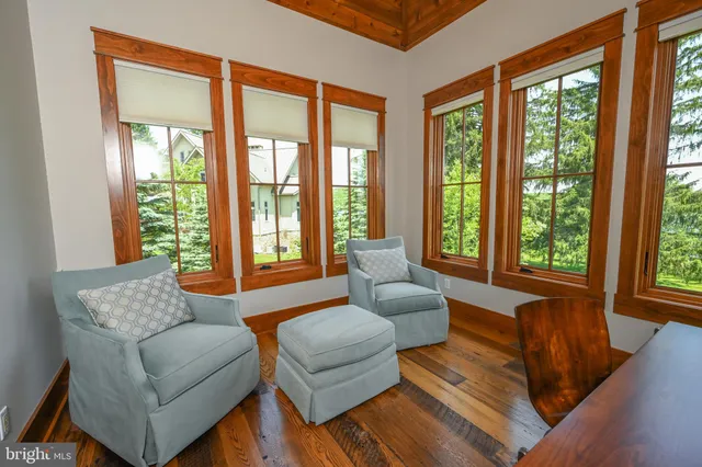a living room with furniture large window and a fireplace