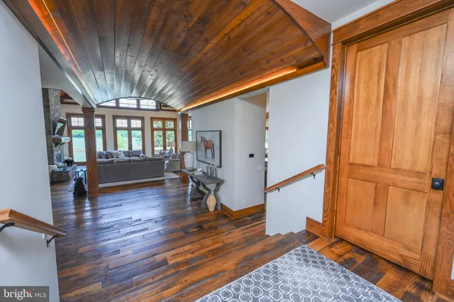 a bathroom with a double vanity sink toilet mirror and shower