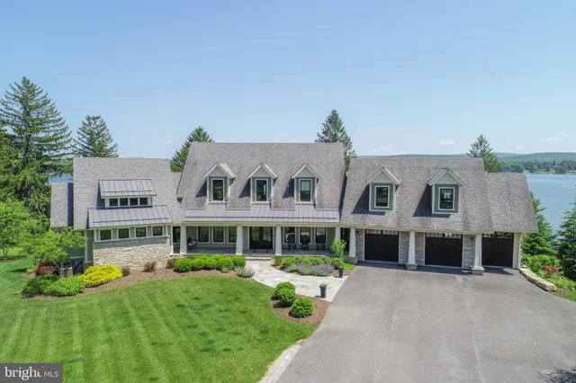 a kitchen with stainless steel appliances granite countertop a stove a refrigerator a dining table and chairs with wooden floor