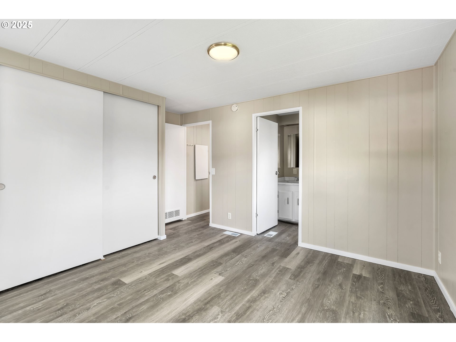10701 Southeast Highway 212, Unit J3 Clackamas, OR 97015 - Photo 14 of 42 a view of an empty room with wooden floor