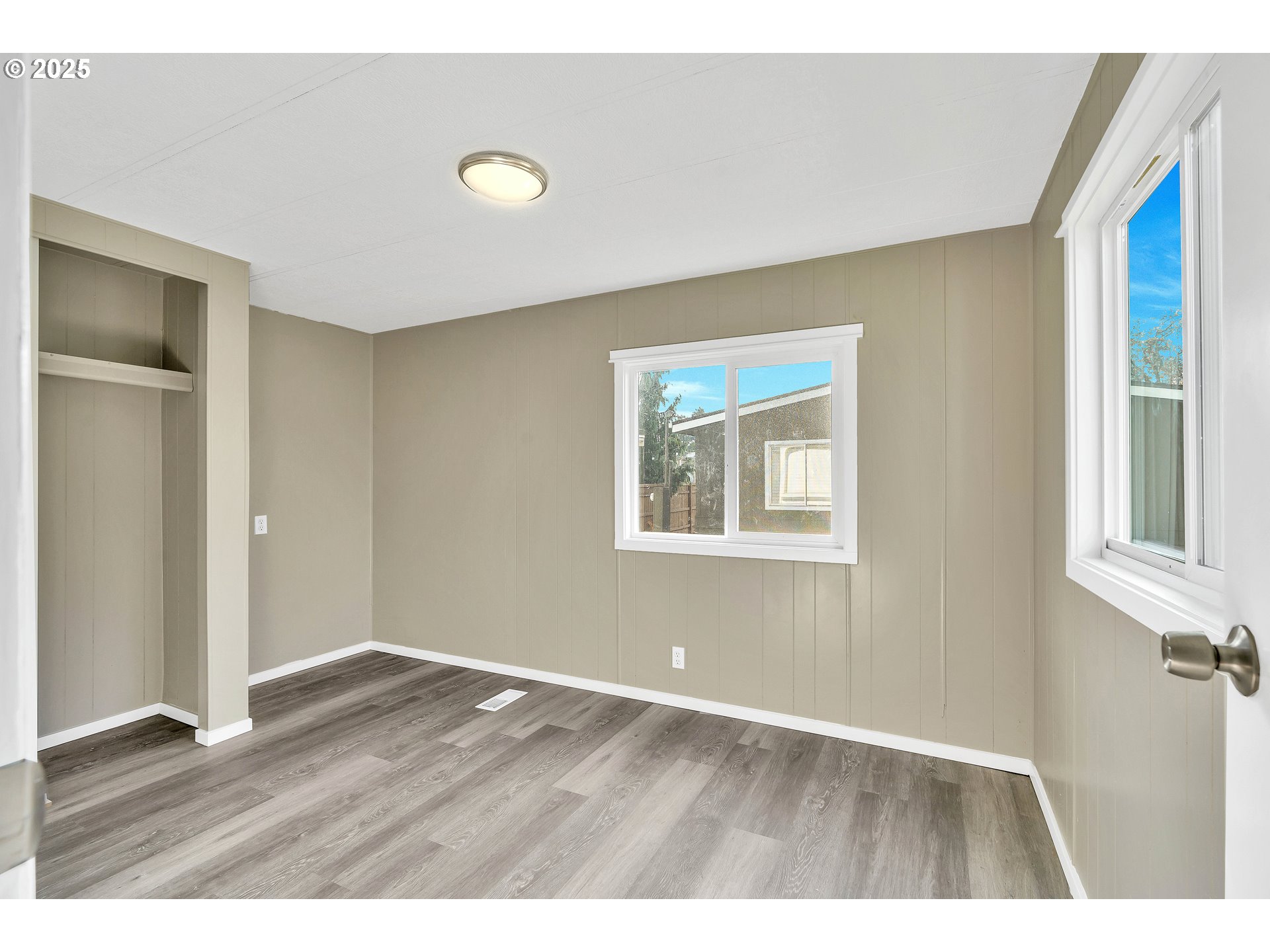 10701 Southeast Highway 212, Unit J3 Clackamas, OR 97015 - Photo 20 of 42 a view of an empty room with wooden floor and a window