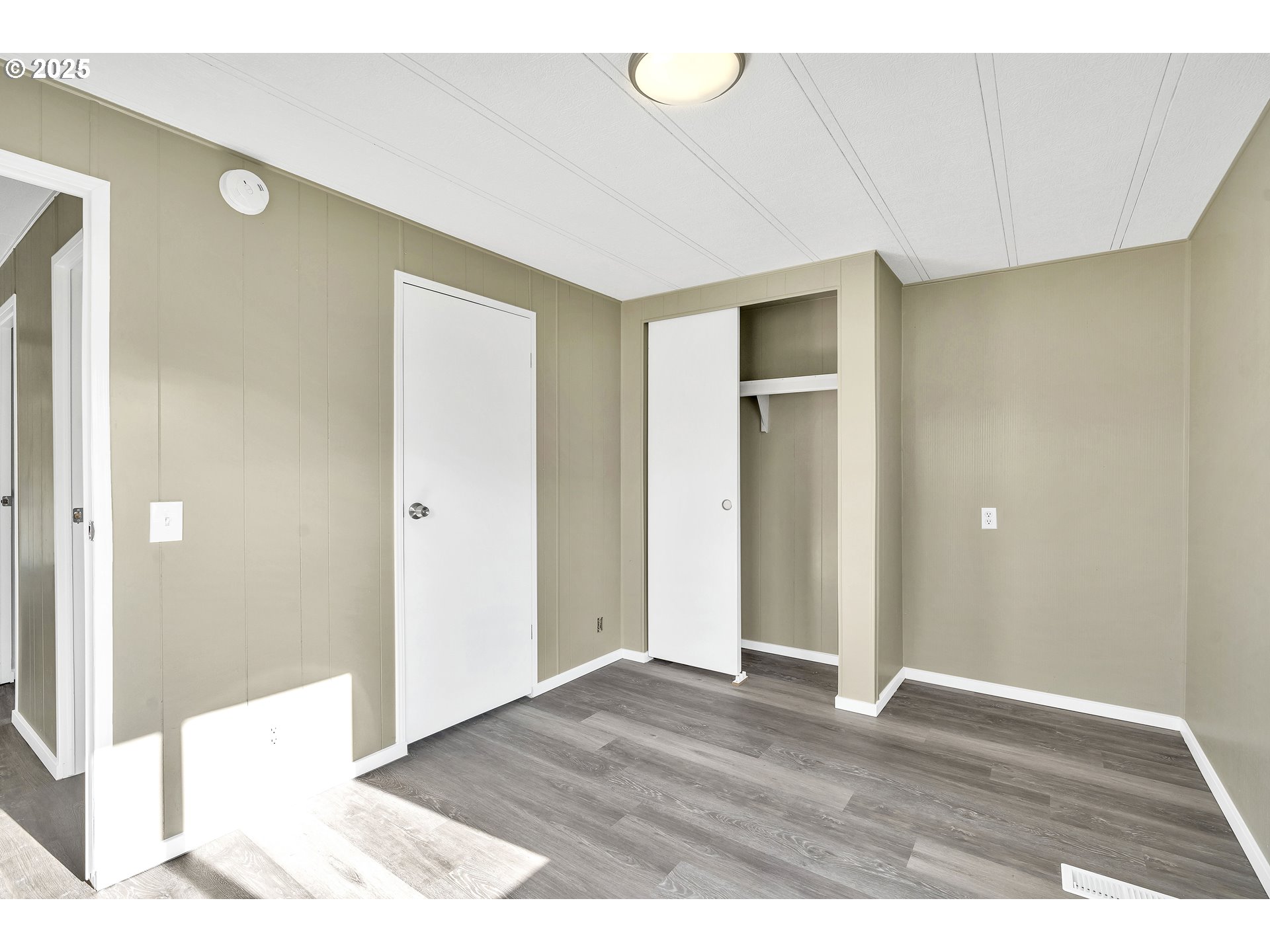 10701 Southeast Highway 212, Unit J3 Clackamas, OR 97015 - Photo 21 of 42 a view of an empty room with wooden floor