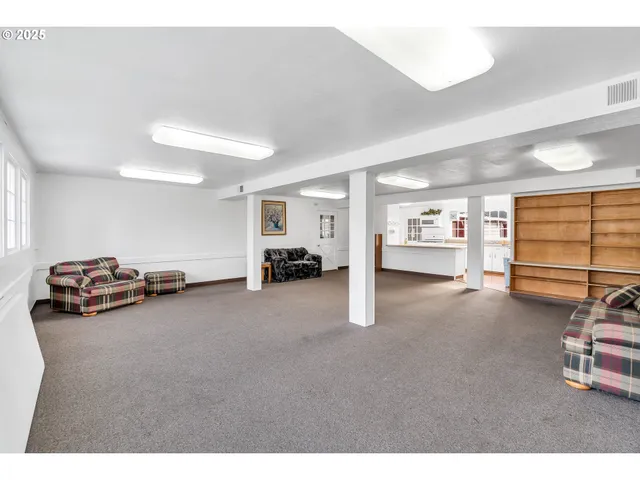 a view of a livingroom with furniture and a window