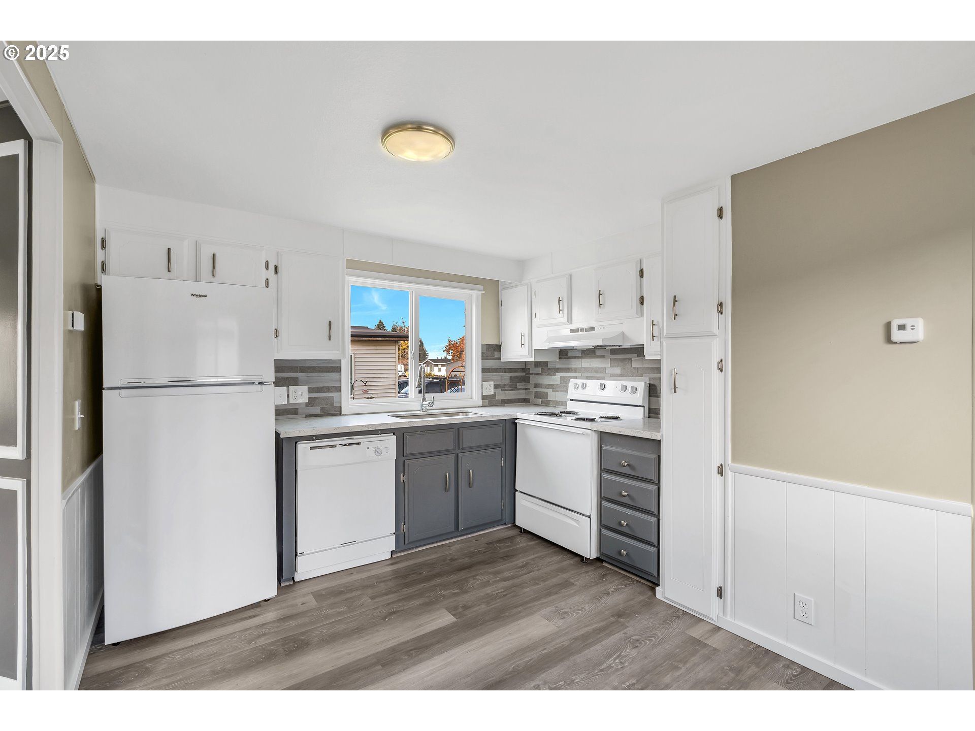 10701 Southeast Highway 212, Unit J3 Clackamas, OR 97015 - Photo 8 of 42 a kitchen with white cabinets and white appliances