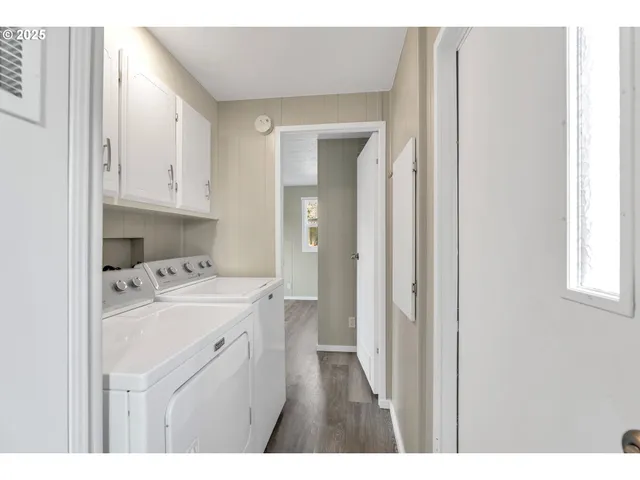 a kitchen view with white cabinets and sink