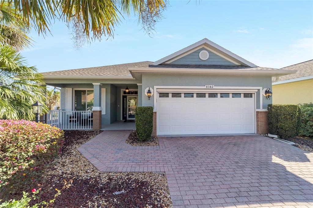 8342 Southwest 82nd Loop Ocala, FL 34481 - Photo 1 of 32 a front view of a house with a yard and garage