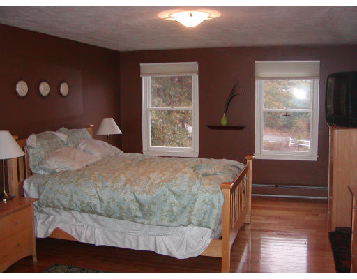 11 Quail Run Road Bellingham, MA 02019 - Photo 13 of 22 a bed sitting in a bedroom next to a window