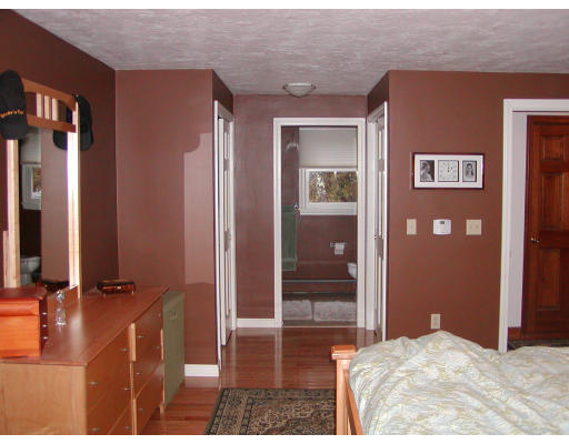 11 Quail Run Road Bellingham, MA 02019 - Photo 14 of 22 a bedroom with a bed and glass door