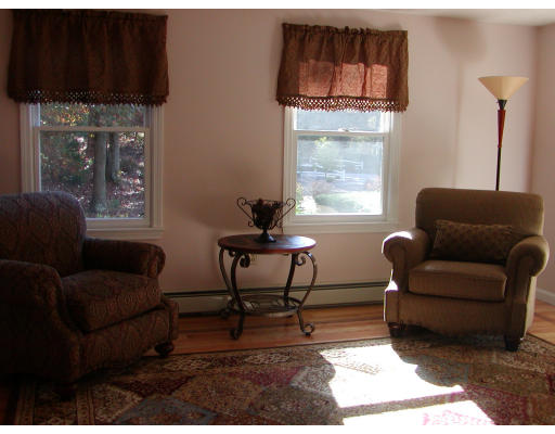 11 Quail Run Road Bellingham, MA 02019 - Photo 20 of 22 a living room with furniture a window and a fireplace
