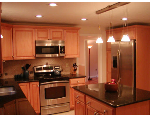 11 Quail Run Road Bellingham, MA 02019 - Photo 5 of 22 a kitchen with stainless steel appliances granite countertop a stove a sink and a microwave