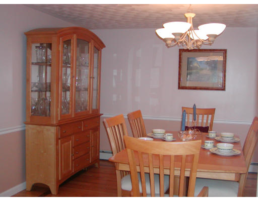11 Quail Run Road Bellingham, MA 02019 - Photo 7 of 22 a dining room with furniture and a chandelier