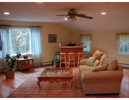 11 Quail Run Road Bellingham, MA 02019 - Photo 9 of 22 a living room with furniture a window and a flat screen tv