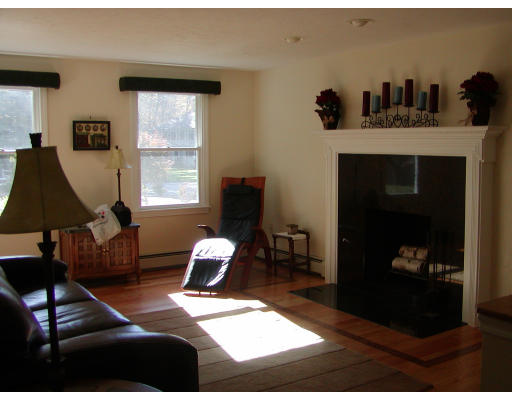 11 Quail Run Road Bellingham, MA 02019 - Photo 10 of 22 a living room with furniture a window and a fireplace